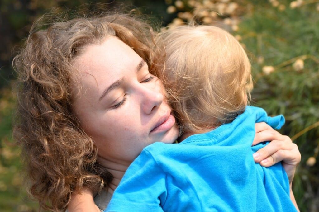 Anxious Attachment Style: Can You Change It? 19 mom holds her little baby boy with anxious attachment in her arms
