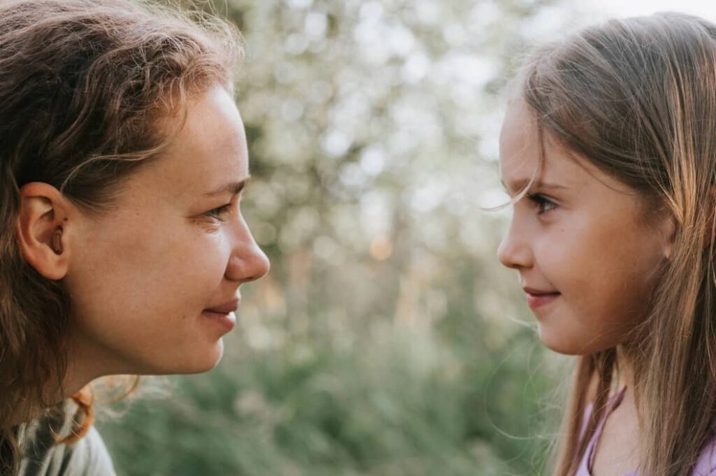 Healing Your Inner Child: Addressing Childhood Trauma 28 a woman looking at her inner child and finding healing