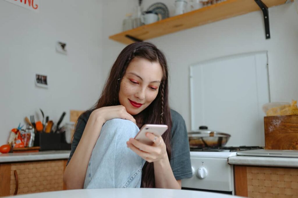 teenager feeling happy after online therapy on her phone