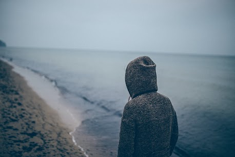 lonely man walking on the beach wondering why he hates being around people